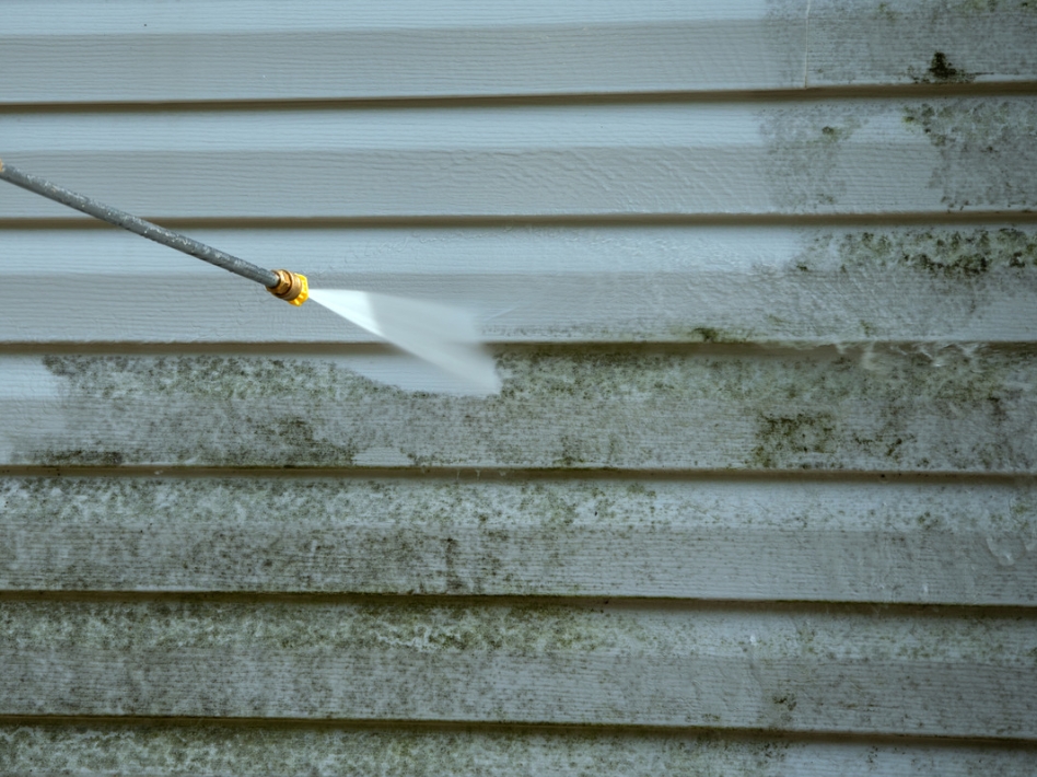 Exterior house washing showing professional cleaning process and dramatic results